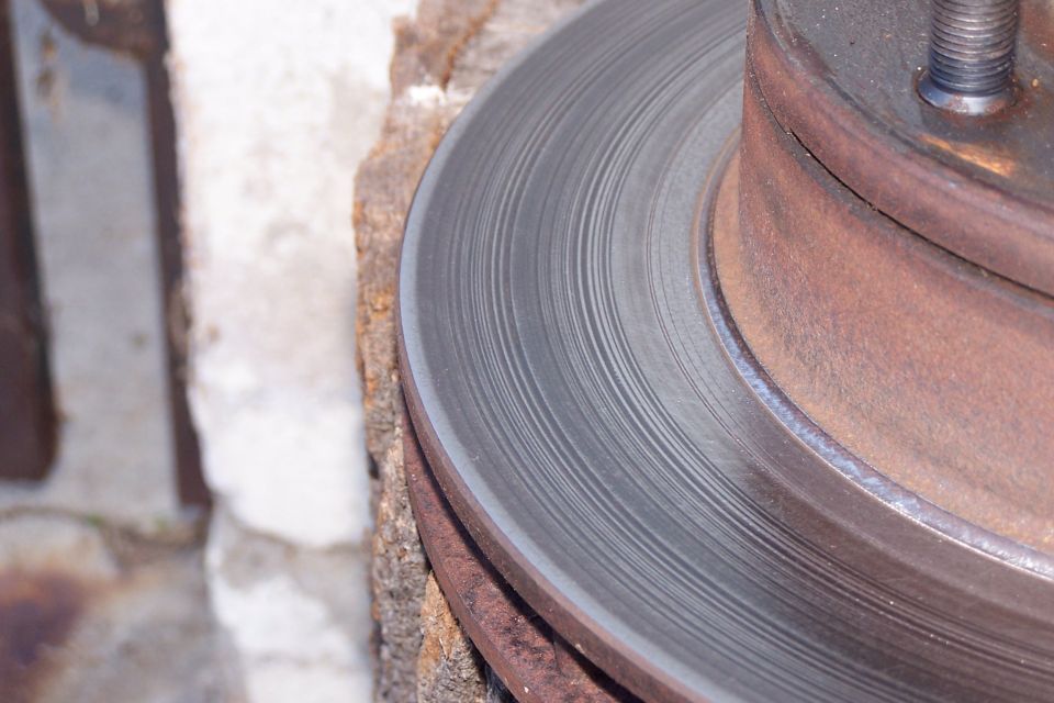 Close-up of a rusty brake rotor with visible wear marks
