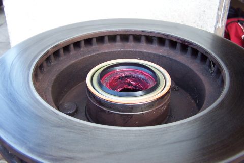 1990 Ford Bronco - Wheel bearing assembly packed with red grease, ready for installation.