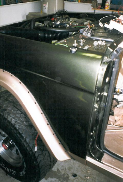 1975 Ford Bronco - Bushwackers, Crown Vic intake, & driver's vent blockoff plate. The connector hanging in the wheelwell is for the power antenna. Note that t…