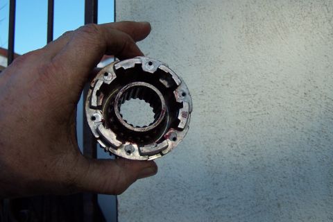 1990 Ford Bronco - A hand holds a metal component with internal splines, likely a vehicle part.