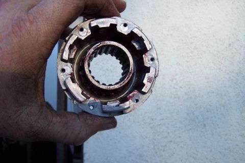 1990 Ford Bronco - Close-up of a metal automotive part with splines inside, held by a hand.