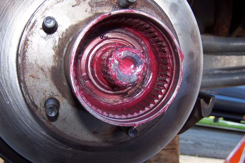 1990 Ford Bronco - Close-up of a greased wheel hub assembly, showing internal splines and a central nut.