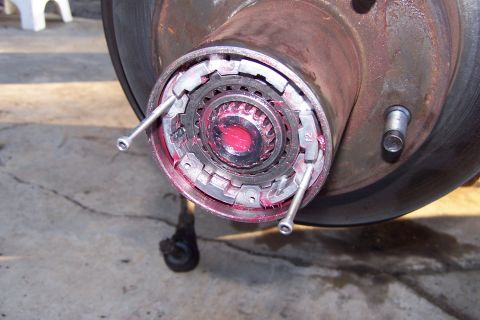1990 Ford Bronco - Wheel hub assembly showing internal splines and locking mechanism, covered in red grease.