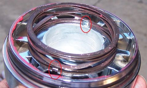 1990 Ford Bronco - Ball joint assembly with red grease, showing internal components.