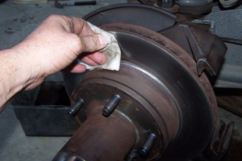 1990 Ford Bronco - Cleaning the brake rotor to remove surface rust before reassembly.