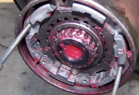 1990 Ford Bronco - This image shows a close-up view of a vehicle's wheel hub assembly, covered in red grease.