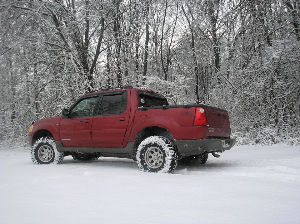 Red 2002 Ford Sport Trac in snow, rear view