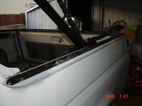 1993 Ford Bronco - Interior view of a 1993 Ford Bronco, focusing on the soft top frame and rear compartment.