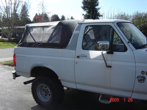 1993 Ford Bronco - This 1993 Ford Bronco features a removable soft top, offering a versatile open-air experience.