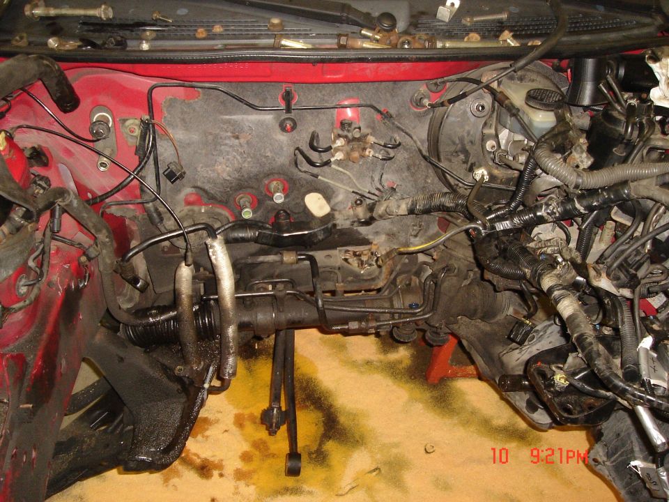 Engine bay with exposed steering rack and brake lines