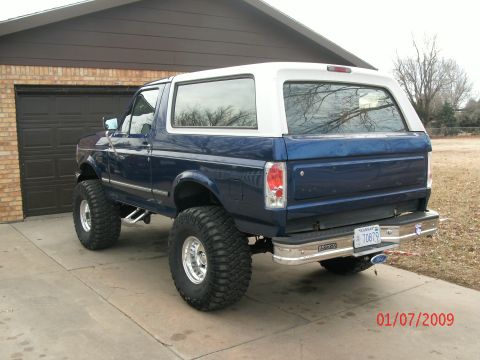 1996 Ford Bronco - This lifted 1996 Ford Bronco is parked in front of a garage.