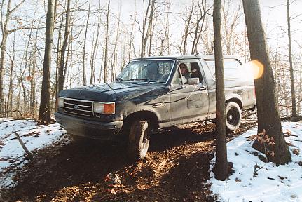 1989 Ford Bronco - First time wheeling on club land. Navigating between and around some trees. Club land in Stvensville, MI. 12/9/02.
