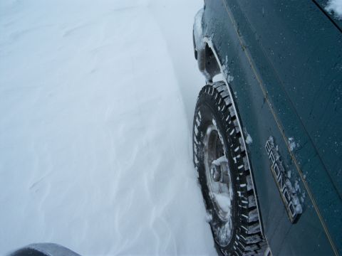1996 Ford Bronco - Driving a 1996 Ford Bronco through deep snow, with the 'BRONCO' emblem visible on the door.