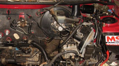 1993 Ford Probe - This image shows various engine bay components, including the brake master cylinder and ABS module.