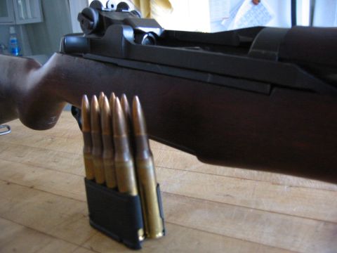1996 Ford Bronco - A rifle is shown with a magazine loaded with cartridges resting on a wooden table.