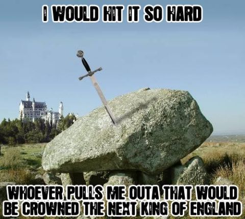 1992 Ford Taurus - A sword is stuck in a rock, with a castle visible in the distance, under a blue sky.