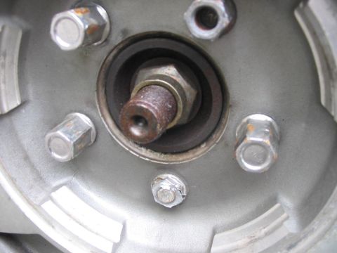 1984 Ford Bronco - This image shows a close-up view of a vehicle's wheel hub assembly, including lug nuts and a central bolt.