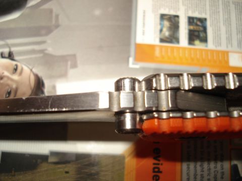 2000 Ford Crown Victoria - A close-up view of a knife's blade and handle is shown, with a magazine visible in the background.