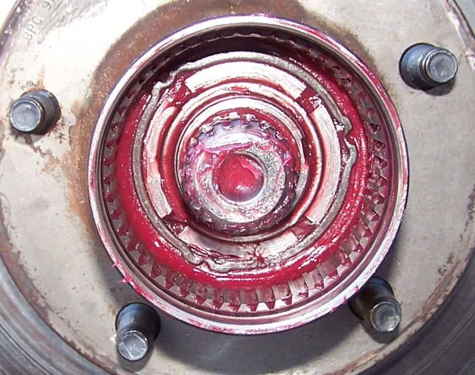 close-up of wheel hub assembly with red grease