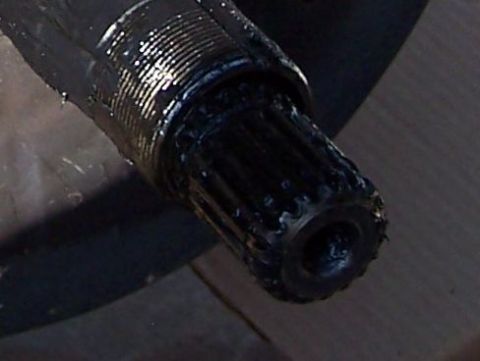 1990 Ford Bronco - Close-up of a greased splined shaft end, a component likely from a vehicle's drivetrain or suspension system.