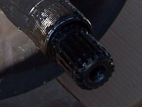 Splined shaft end covered in black grease