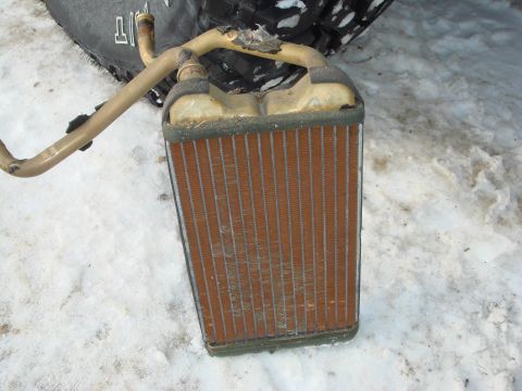 1991 Toyota Tacoma - A damaged heater core with bent pipes rests on a snowy surface.