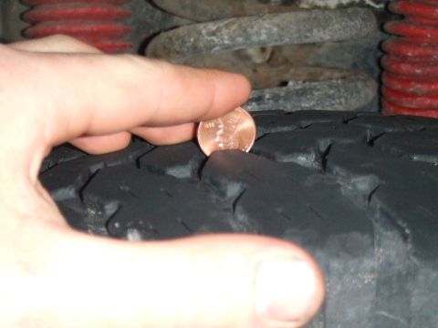 1996 Ford Bronco - Checking tire tread depth with a penny.