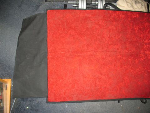 1997 Ford Crown Victoria - A car cover is laid out on the floor, with weights visible in the background.
