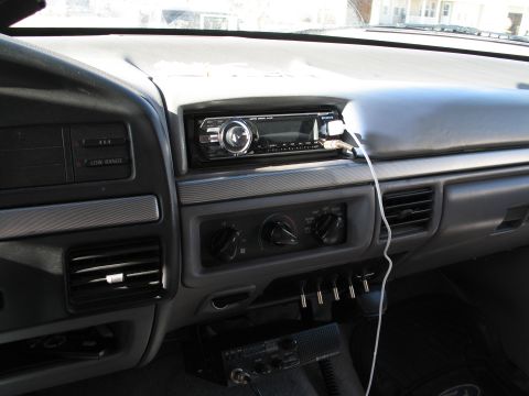 1995 Ford Bronco - The interior of a vehicle shows a Sony stereo, climate controls, and a CB radio mounted below the dash.