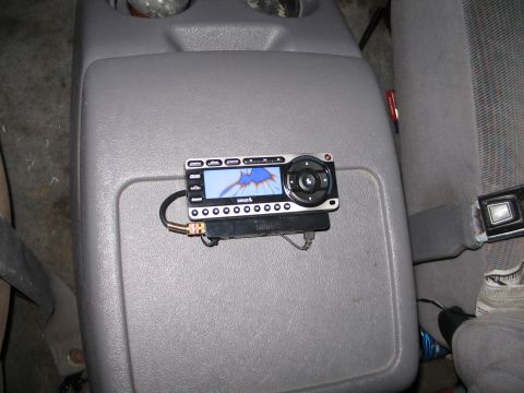 1995 Ford Bronco - A Sirius radio is mounted on the center console of a vehicle.
