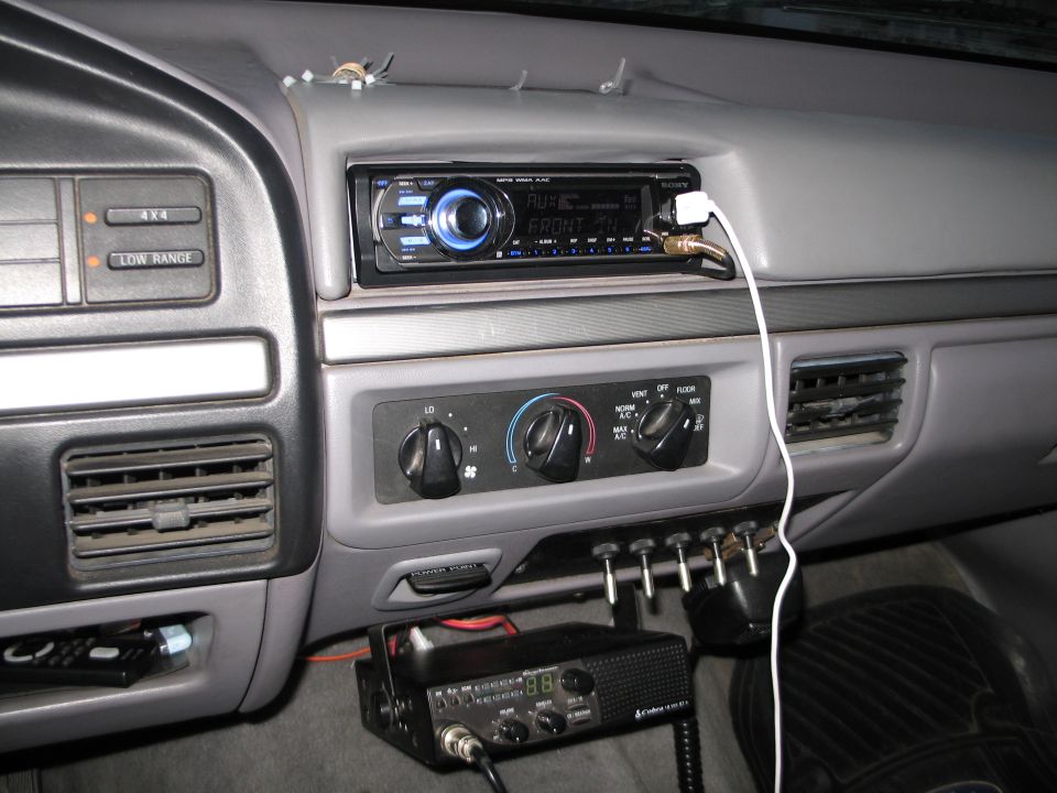 1995 Ford Bronco interior showing aftermarket Sony stereo, climate controls, and Cobra CB radio