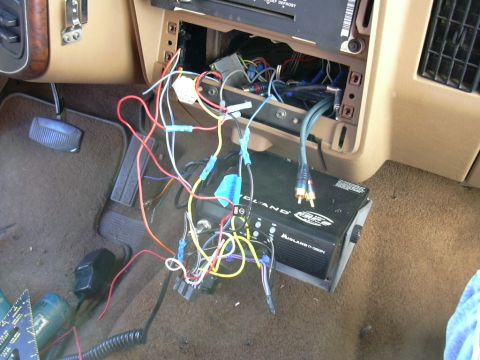 1991 Ford Bronco - Car interior with exposed wiring and amplifier installation.
