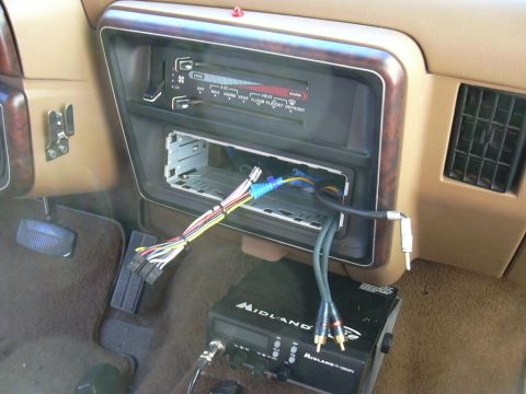 1991 Ford Bronco - Aftermarket radio and CB radio installation in a vehicle's dashboard.