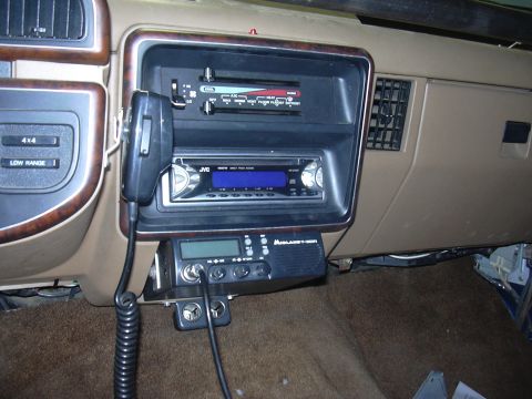 1991 Ford Bronco - The interior of a vehicle shows a dashboard with aftermarket audio equipment and 4x4 controls.