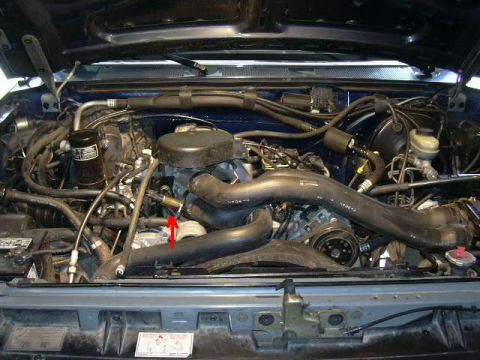 1991 Ford Bronco - Close-up view of the engine compartment, showing various mechanical parts and wiring.