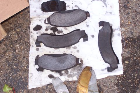 1990 Ford Bronco - New brake pads are ready for installation, suggesting maintenance or repair work.