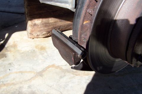 1990 Ford Bronco - This image shows a close-up view of a vehicle's brake system, highlighting a worn brake pad and rotor.
