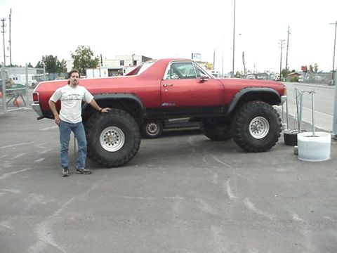 1978 Ford Bronco - This red pickup truck has been heavily modified with large off-road tires.
