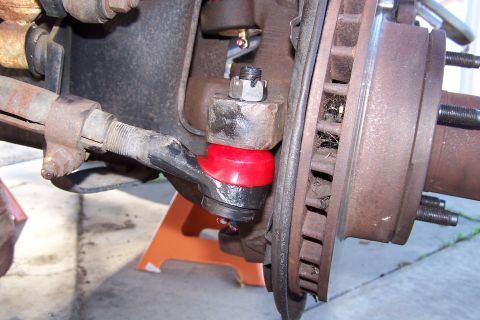 1990 Ford Bronco - This is a close-up view of a vehicle's steering and suspension components, specifically a ball joint and tie rod end.