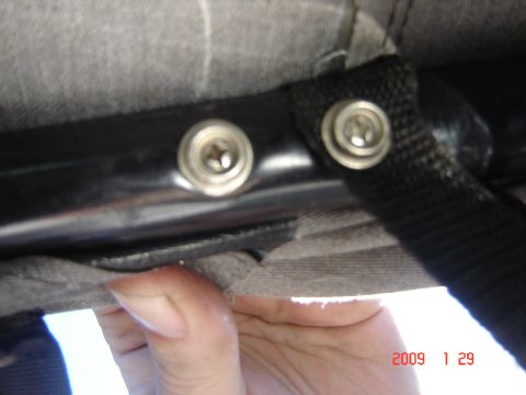 1993 Ford Bronco - Interior trim panel detail with visible screws and strap attachment points.