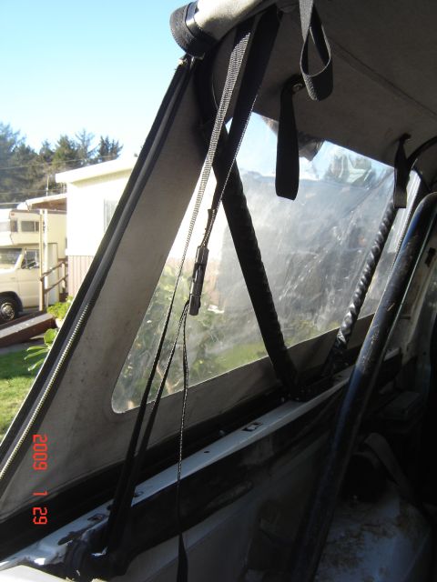 1993 Ford Bronco - Interior view of a 1993 Ford Bronco's soft top, showing the rear window and straps.