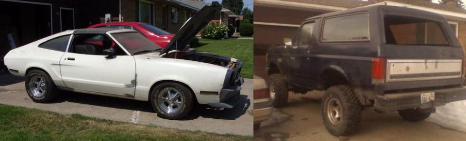 White coupe with hood up parked next to a dark SUV in driveways