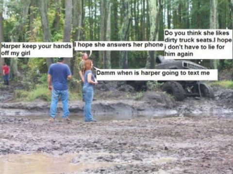 2004 Jeep Wrangler - People stand around a vehicle stuck deep in the mud in a wooded area.
