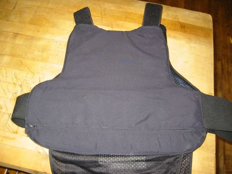 1996 Ford Bronco - A black tactical vest is displayed on a wooden surface.