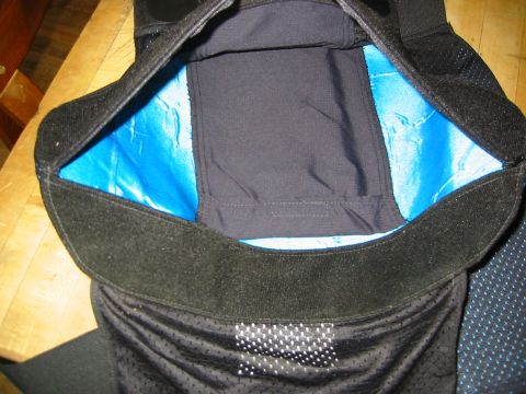 1996 Ford Bronco - Close-up of black motorcycle knee pads blue lining and adjustable velcro straps.