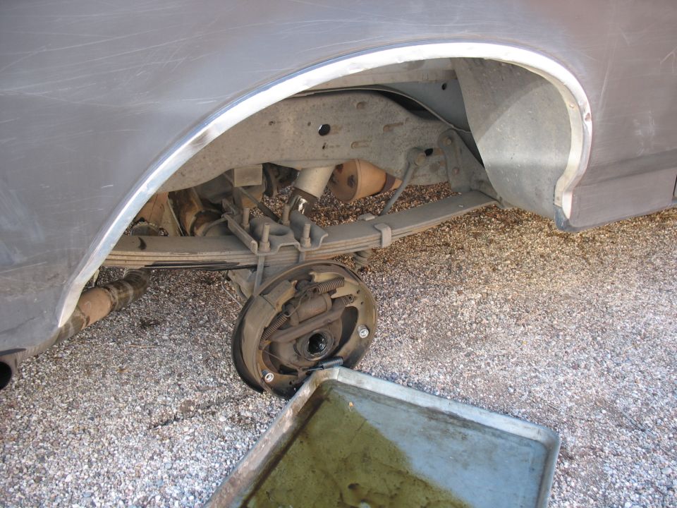 Close-up of a beige and brown vehicle dashboard with circular vents and a speaker grille