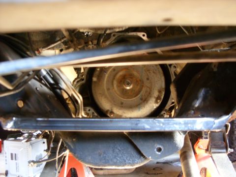 1988 Ford Bronco - A low-angle view of a vehicle's undercarriage, showing the transmission and exhaust components.