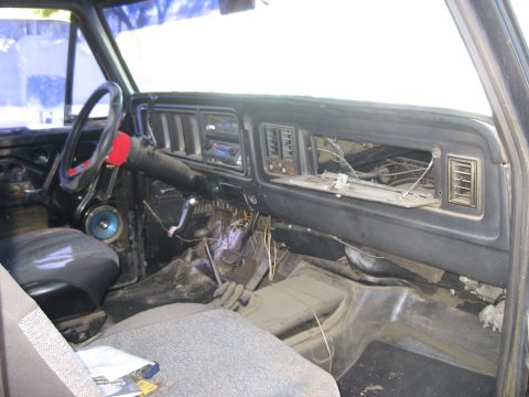 1979 Ford Bronco - The interior of a 1979 Ford Bronco shows its dashboard with an aftermarket radio and a missing glove box door.