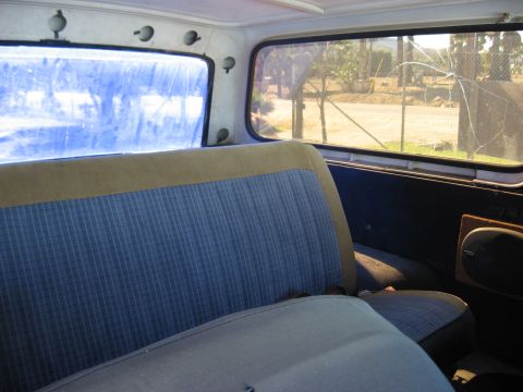 1979 Ford Bronco - Rear interior view of a 1979 Ford Bronco, highlighting the seat fabric and window condition.