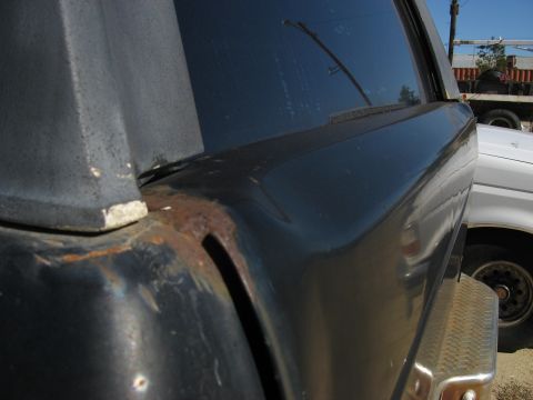 1979 Ford Bronco - Close-up of the rear corner of a 1979 Ford Bronco, showing some rust damage.